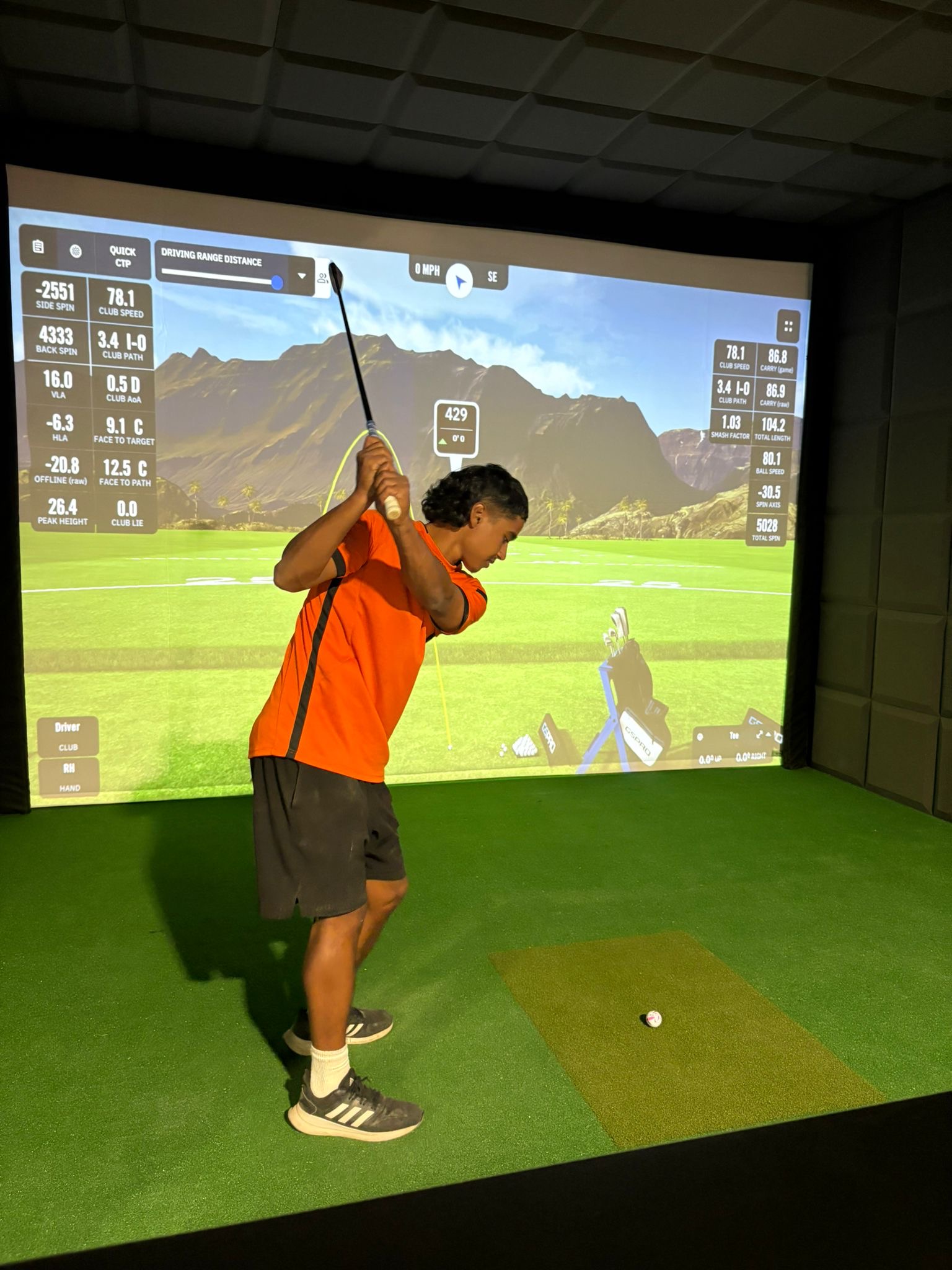 a golfer in the golf sim at Sandbach SportsZone.